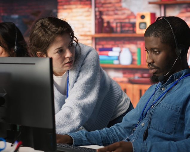 Call center manager teaching intern how to track clients shipment parcels. Customer center team leader doing induction to trainee, locating clients packages and providing status updates, camera A